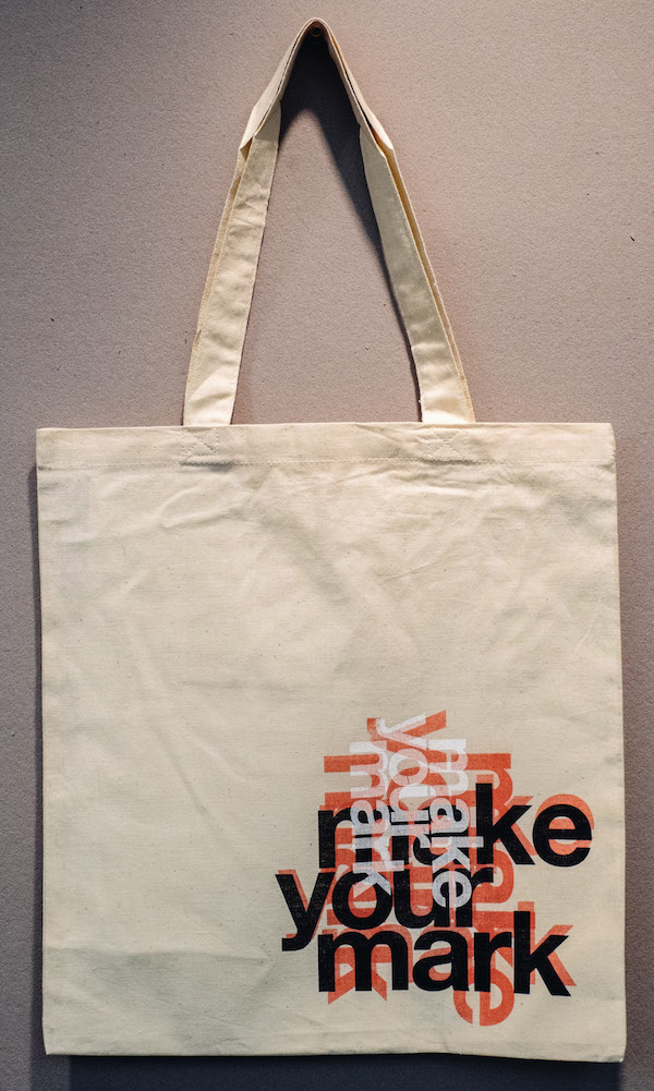 MAKE YOUR MARK Tote Bag: Red, black and white letters on khaki; designs vary