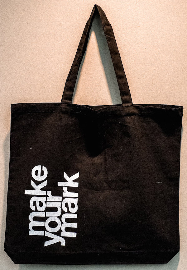 MAKE YOUR MARK Tote Bag: White letters on black; designs vary